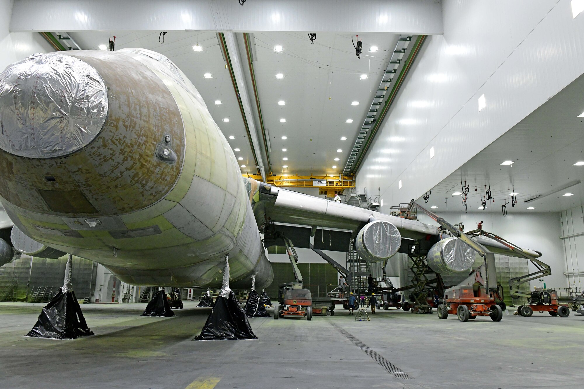 painters preparing aircraft for painting
