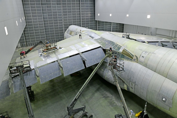 Painters preparing aircraft for paint
