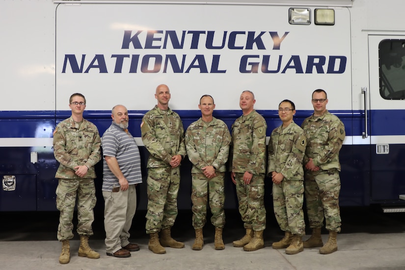 U.S. Army Chief Warrant Officer 5 David Barker, Joint Forces Headquarters, Kentucky National Guard, was recognized for his service during a retirement ceremony in Frankfort, Ky, April 27, 2023. Barker and is team from G6 Mission Command pose for one last photo together. (U.S. Army National Guard photo by Lt. Col. Carla Raisler Kentucky National Guard)