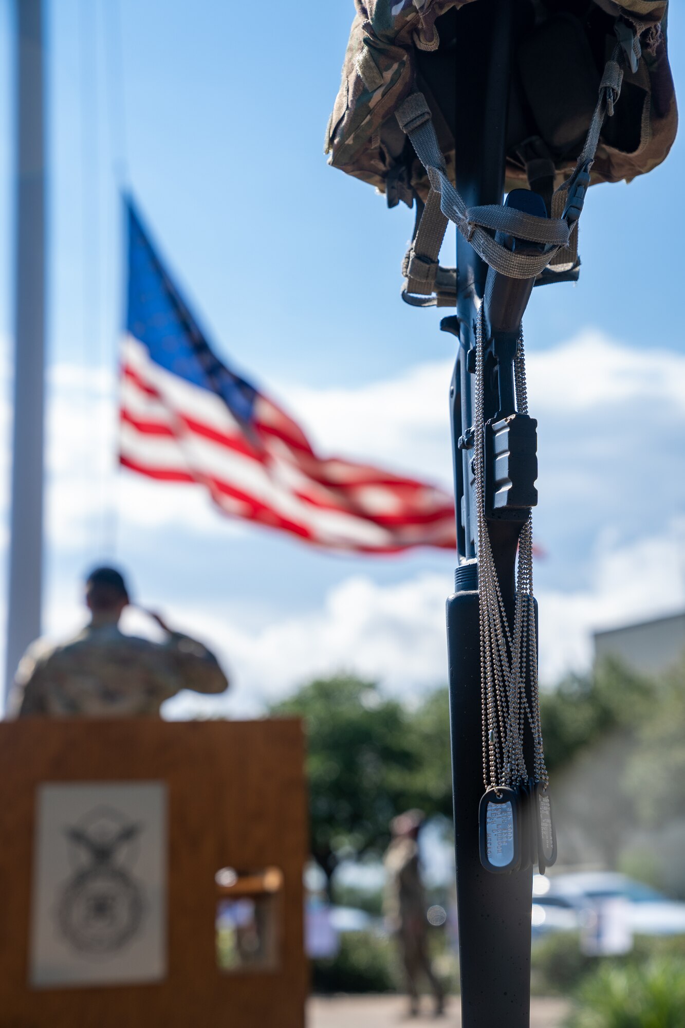 Airmen from 81st Security Forces Squadron lower the American flag during the retreat ceremony for National Police Week at Keesler Air Force Base, Mississippi, May 19, 2023.