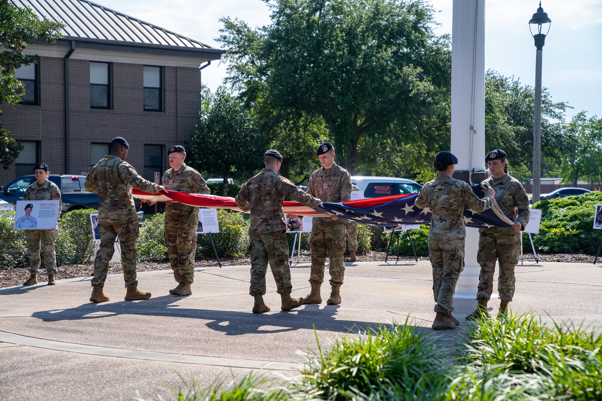 Airmen from 81st Security Forces Squadron fold the American flag during the retreat ceremony for National Police Week at Keesler Air Force Base, Mississippi, May 19, 2023.