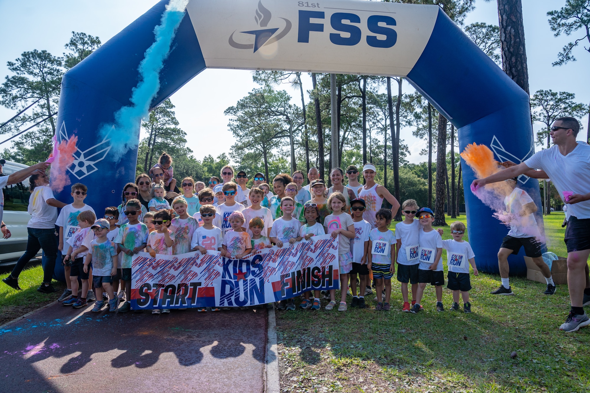 Airmen from the 81st Training Wing and families pose for a group photo before the start of the Armed Forces Day Color Run at Keesler Air Force Base, Mississippi, May 20, 2023.