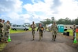 Senior Airman Kevin Buckner (middle), fire protection with the 151st Civil Engineering Squadron, Utah National Guard, carries a pineapple while rucking more than six miles for the mystery event during the Region VII Best Warrior Competition on the Hawaiian Island of Oahu, May 7-11, 2023. The Best Warrior Competition is an annual Army-sponsored event designed to measure the Soldier’s physical fitness, mental acuity, and demonstrated skill in warrior tasks and battle drills. The Soldier and Noncommisioned Officer of the Year for the region will advance to the All Guard National Best Warrior Competition in Alaska.