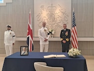 Vice Adm. Johnny Wolfe, Jr., Director, Strategic Systems Programs (right) offers condolences to Royal Navy Commodore Roger Readwin (left), the British Naval Attaché following the signing of the official condolence book for during a remembrance ceremony for Her Late Majesty Queen Elizabeth II at the British Embassy. Wolfe’s visit underscored the importance of the special alliance between the United States and the United Kingdom, which includes the Polaris Sales Agreement, an international treaty established between the U.S. and the UK in April 1963. The agreement provides for the sale to the UK of the Trident Strategic Weapon System. (British Embassy Photo/Released).