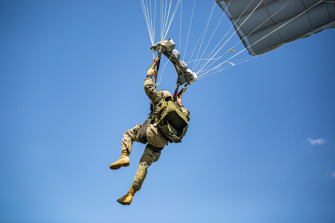 A U.S. Marine with 3rd Force Reconnaissance Battalion glides while parachuting from a UH-1Y Venom helicopter with Marine Light Attack Helicopter Squadron 773, 4th Marine Aircraft Wing, Marine Forces Reserve in support of Special Purpose Marine Air-Ground Task Force UNITAS LXIII, at Santa Cruz Air Force Base, Rio de Janeiro, Sept. 6, 2022. UNITAS LXIII air and parachute operations are part of an integrated, multinational event to enable interoperability and the sharing of knowledge between partner nation forces supporting the exercise. UNITAS is the world's longest-running annual multinational maritime exercise that focuses on enhancing interoperability among multiple nations and joint forces during littoral and amphibious operations in order to build on existing regional partnerships and create new enduring relationships that promote peace, stability, and prosperity in the U.S. Southern Command’s area of responsibility.