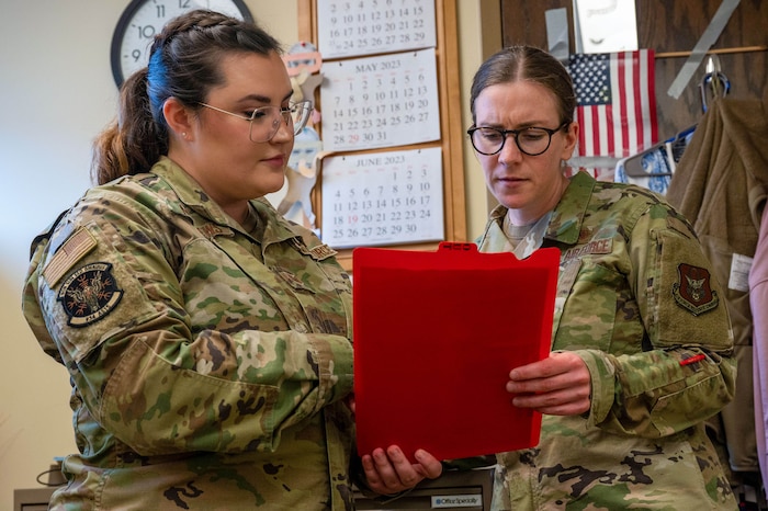 Capt. Mackenzie Kampa, the 934th Aeromedical Staging Squadron mental health officer in charge, right, and Tech. Sgt. Julia Matthews, the 934 ASTS medical case manager, review patient files at the Minneapolis-St. Paul Air Reserve Station, Minnesota, May 6, 2023. The 934 ASTS mental health office was open for walk-ins during the May 2023 unit training assembly to answer a variety of questions regarding mental health, from depression to the resources on base that Airmen can turn to in times of need. (U.S. Air Force photo by Senior Airman Matthew Reisdorf)