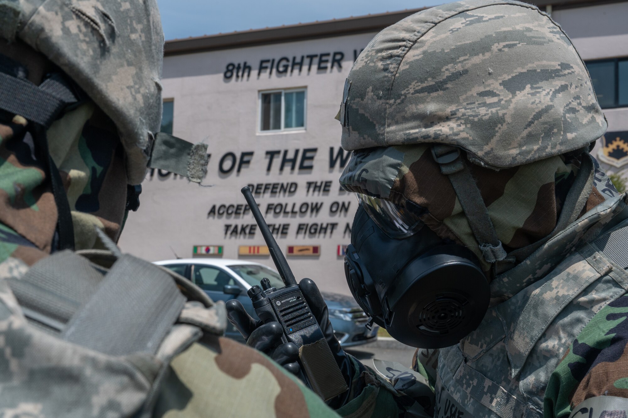 8th Fighter Wing protocol officer, radios a situation report in a simulated post-attack reconnaissance sweep during a training event at Kunsan Air Base