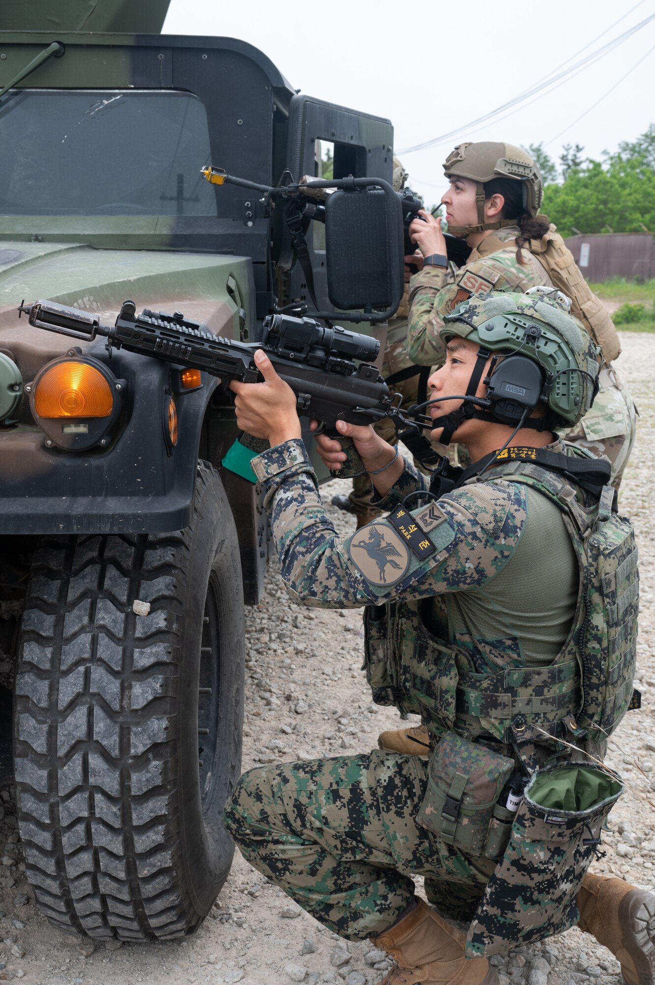A Republic of Korea Army soldier provides simulated cover fire alongside a U.S. Air Force 8th Security Forces Airman during a training event at Kunsan Air Base