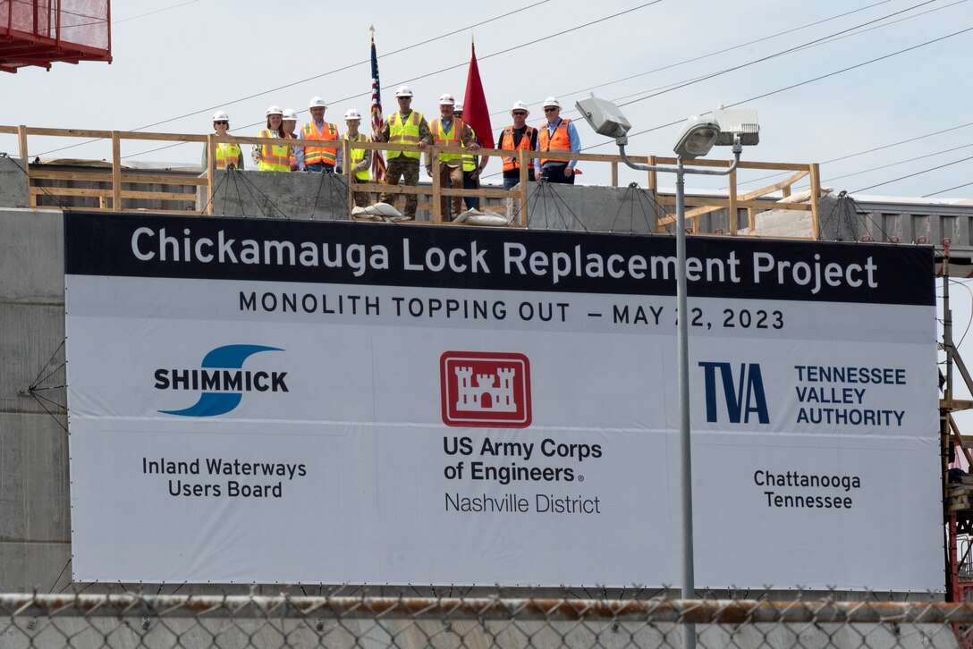 Officials stand atop the first completed monolith May 22, 2023, which is part of the new lock chamber for the Chickamauga Lock Replacement Project on the Tennessee River in Chattanooga, Tennessee. The U.S. Army Corps of Engineers Nashville District and its contractor, Shimmick, held a topping off ceremony marking the completion of the first of 36 monoliths. (USACE Photo by Lee Roberts)