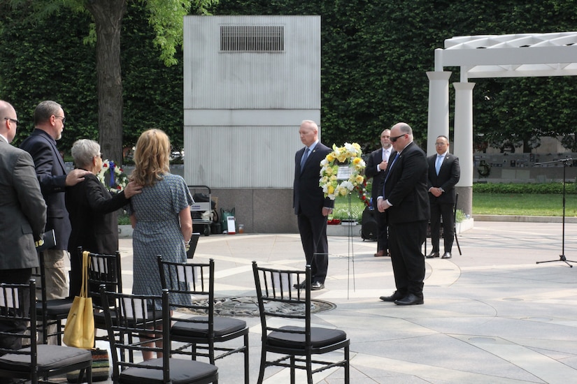 The family of Special Agent Elmer "Bud" Heggen provide each other support during a ceremony at the National Law Enforcement Officers Memorial.