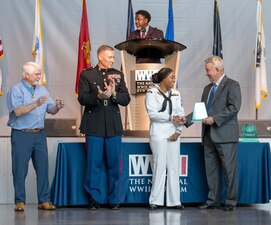 Master-at-Arms 2nd Class Yasmine McMillian is recognized during an Armed Forces Day celebration at the National WWII Museum in New Orleans.