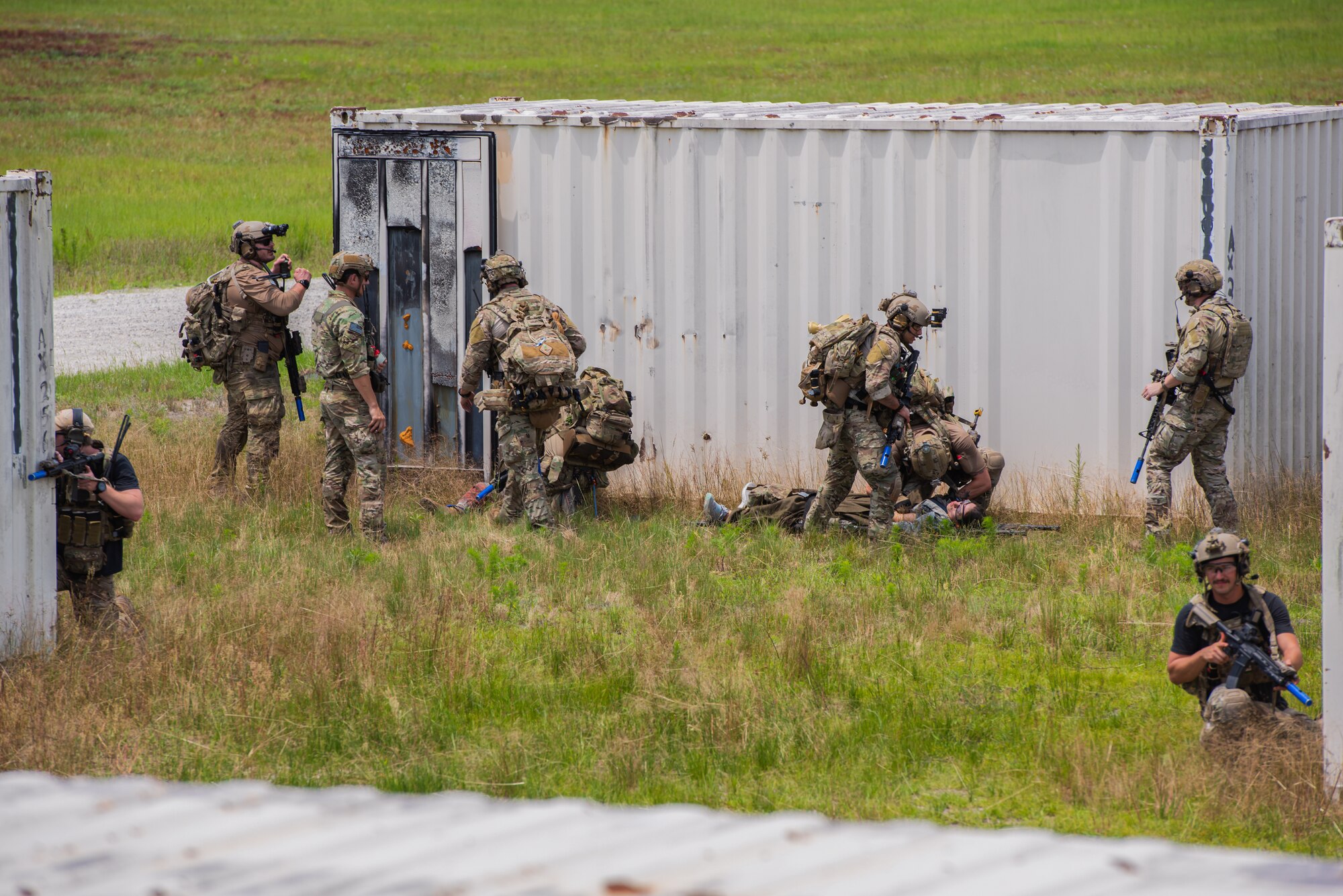 Airmen transporting simulated injured victims