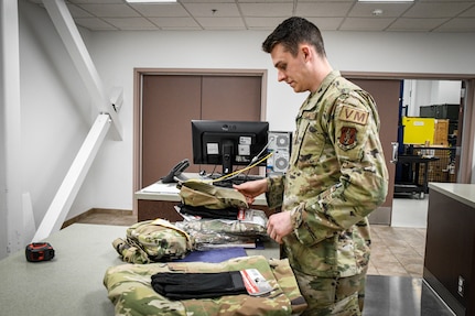 Senior Airman Jakob Stokes, 168th Wing, Alaska Air National Guard, prepares his gear at Eielson Air Force Base to help with flood-recovery efforts in Circle, Alaska, May 23, 2023. Four Guardsmen and one member of the Alaska State Defense Force will assist with cleanup and flood recovery efforts at the request of the Alaska State Emergency Operations Center. (Alaska Air National Guard photo by Senior Master Sgt. Julie Avey)