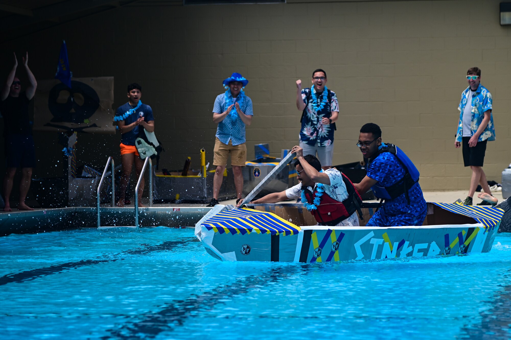 Guardians assigned to the 30th Space Communications Squadron paddle toward the finish line as co-workers and teammates cheer them on during the bi-annual boat regatta on Vandenberg Space Force Base, Calif., May 18, 2023. The Vandenberg SFB Hawk's COVE organized the days events, which promoted the culture of caring for fellow Airmen and Space Force Guardians. (U.S. Space Force photo by Airman 1st Class Ryan Quijas)