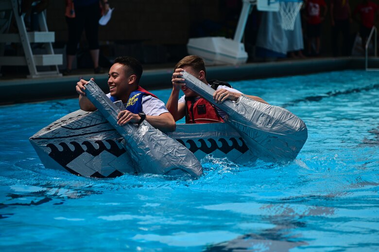Airmen assigned to the 30th Medical Group smile as they row to the finish line during the bi-annual boat regatta on Vandenberg Space Force Base, Calif., May 18, 2023. The boat regatta is the final event of Hawkulture Day, designed by the Vandenberg Hawk's COVE, which promoted the culture of caring for fellow Airmen and Space Force Guardians. (U.S. Space Force photo by Airman 1st Class Ryan Quijas)