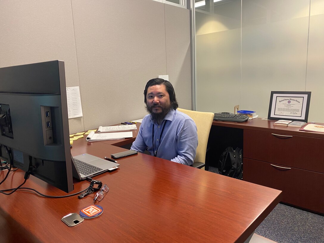 Ken Kajihiro working at his desk for the Transatlantic Middle East District.