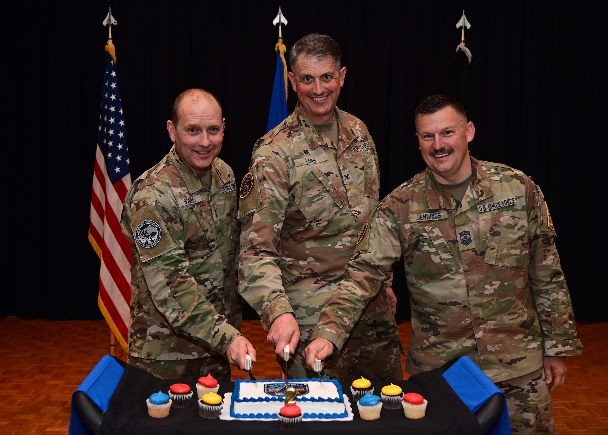 U.S. Space Force Major Gen. Douglas A. Schiess, Combined Force Space Component Command commander, left, U.S. Space Force Col. Robert Long, Space Launch Delta 30 commander, middle, and U.S. Space Force Chief Master Sgt. Heath Jennings, Space Launch Delta 30 senior enlisted leader, pose for a photo during Space Launch Delta 30's second birthday celebration. During his remarks, Col. Long expressed appreciation for the members of SLD 30 and reminded them about the crucial role they play in national security. He highlighted that the base conducted 19 launches in 2022, which were the most at the base in 26 years, and that this year over 30 launches are scheduled. (U.S. Space Force photo by Airman 1st Class Ryan Quijas)