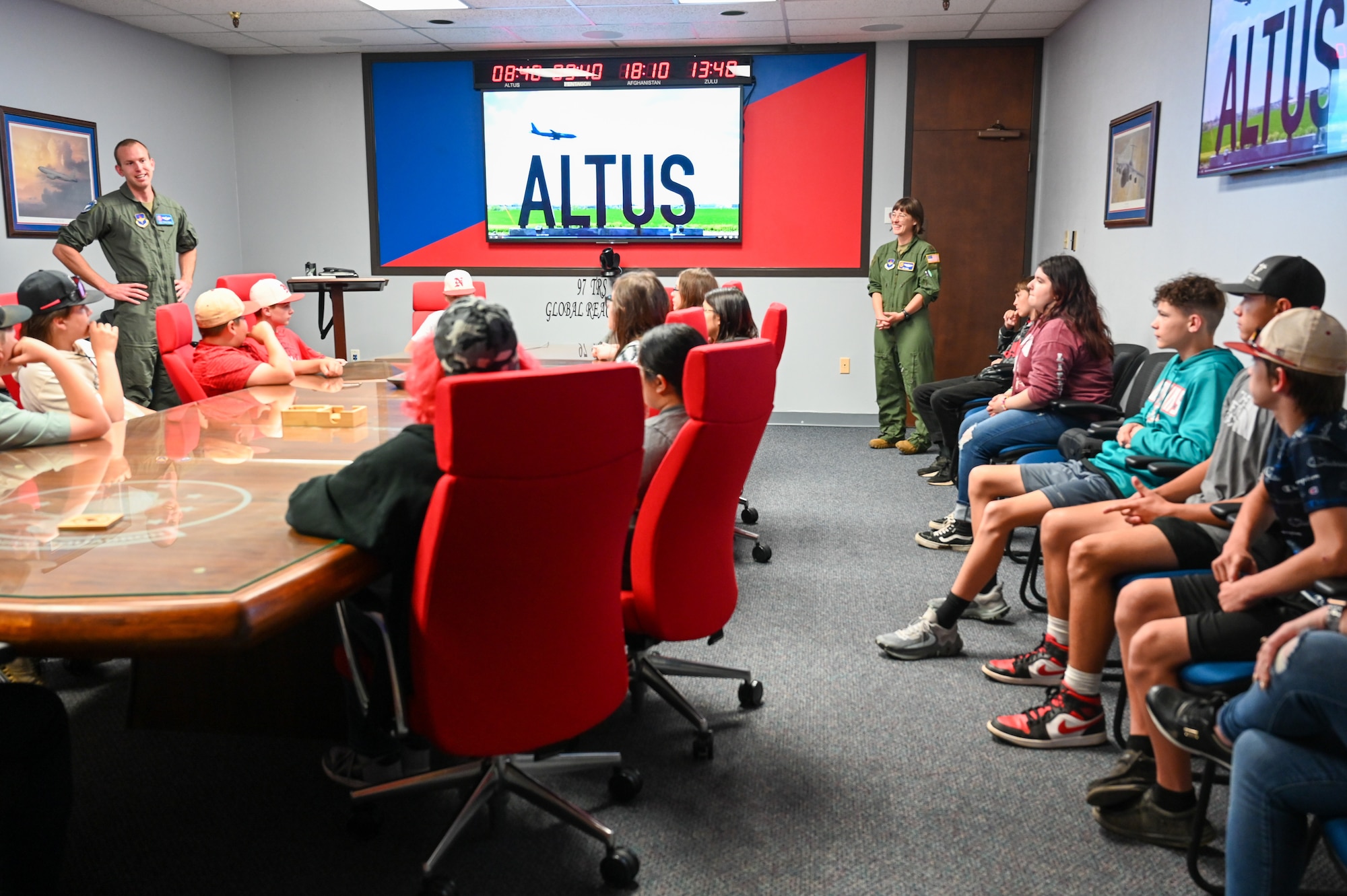 U.S. Air Force Tech. Sgt. Travis Peirce (left), 56th Air Refueling Squadron tactics flight chief, talks with students from Navajo Public Schools to kick off the Aviation Inspiration and Mentorship Wing tour at Altus Air Force Base, Oklahoma, May 10, 2023. Twenty-three students attended the event, which highlighted science, technology, engineering, math and aviation. (U.S. Air Force photo by Airman 1st Class Heidi Bucins)