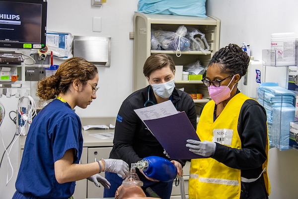 USNMRTC Yokosuka Sailors treat a simulated casualty during a large-scale, multi-day, joint-partner exercise to promote interoperability and readiness at USNH Yokosuka