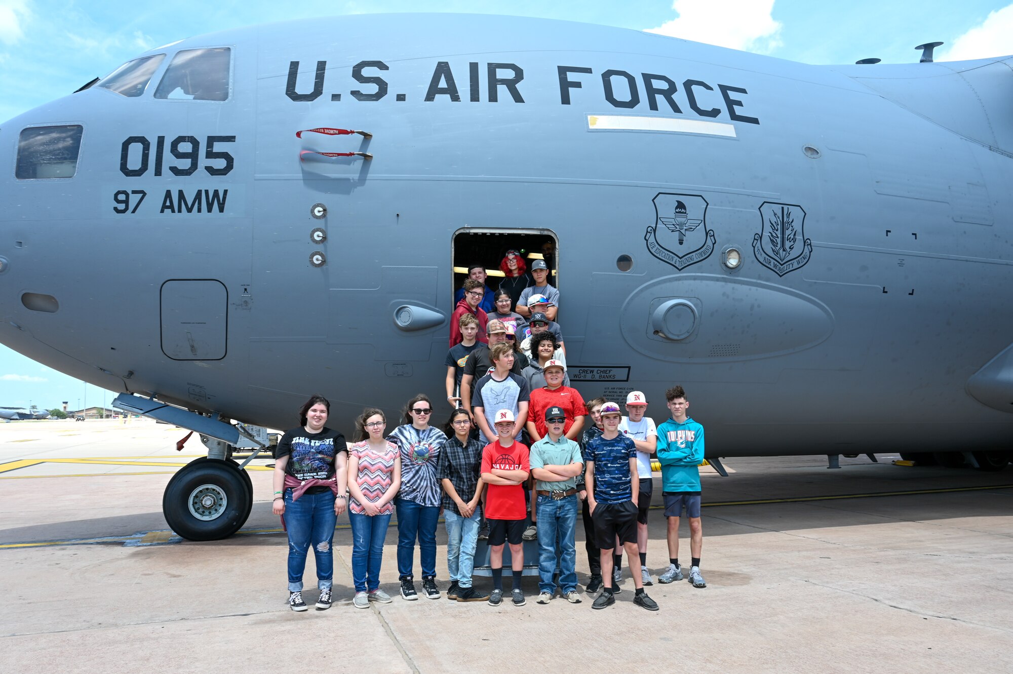 Students from Navajo Public Schools pose for a group photo in front of a C-17 Globemaster III at the Aviation Inspiration and Mentorship Wing tour at Altus Air Force Base, Oklahoma, May 10, 2023. The students had the opportunity to learn about different parts of the aircraft and what responsibilities the aircrew have. (U.S. Air Force photo by Airman 1st Class Heidi Bucins)