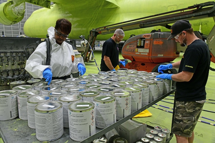 Painters opening paint cans