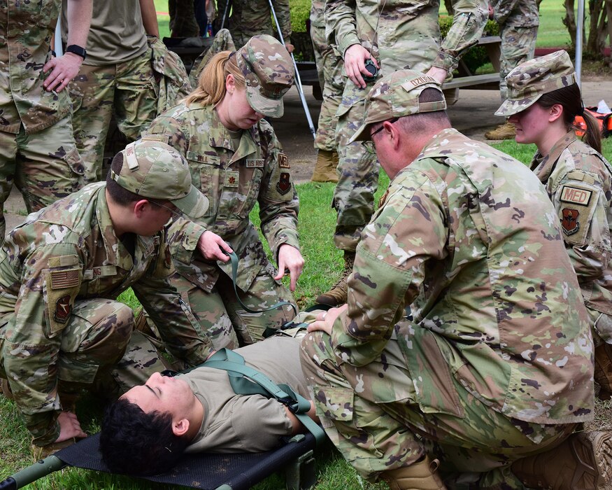 Military members provide care to a simulated patient.