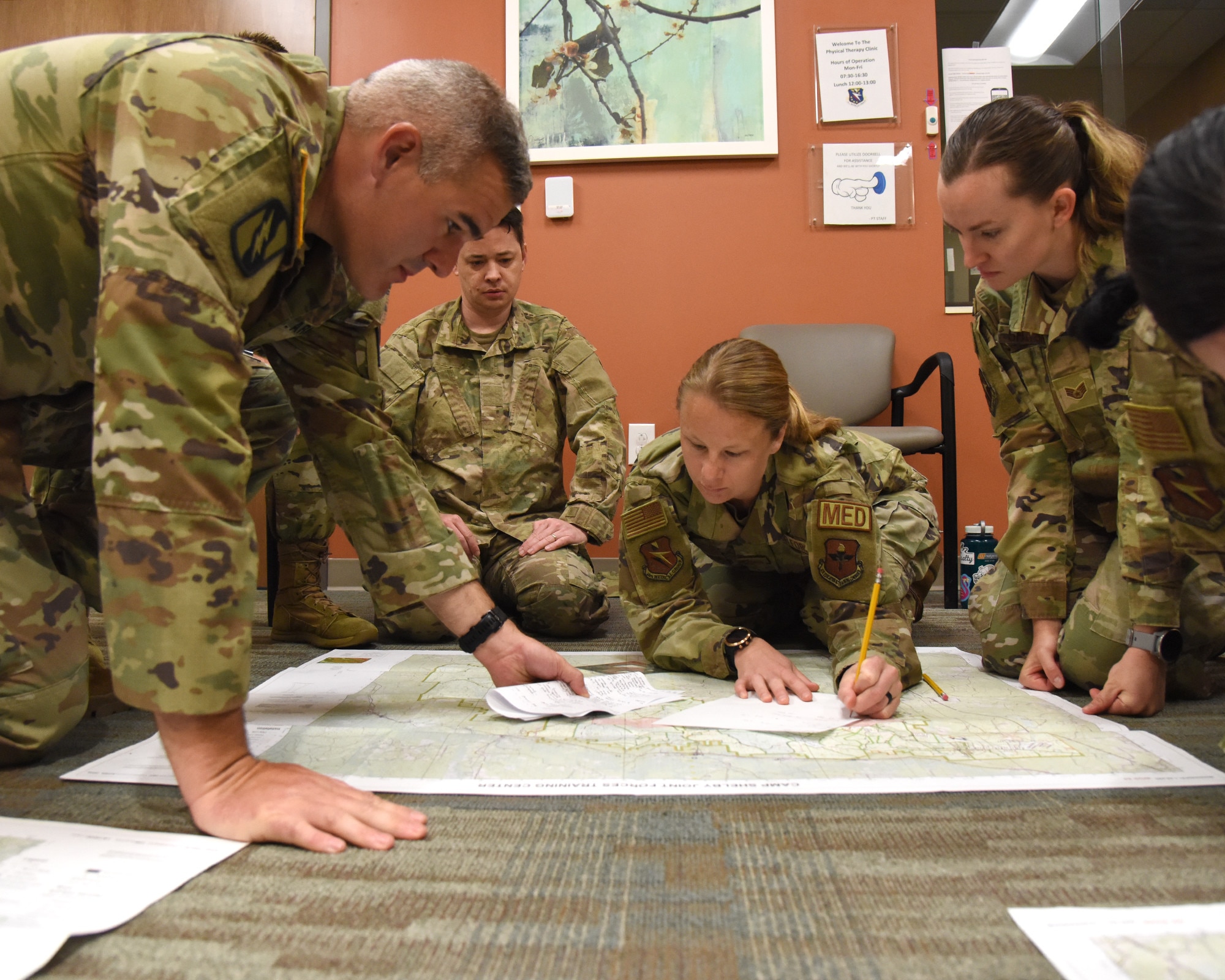 Military members plan mapping points for land navigation.