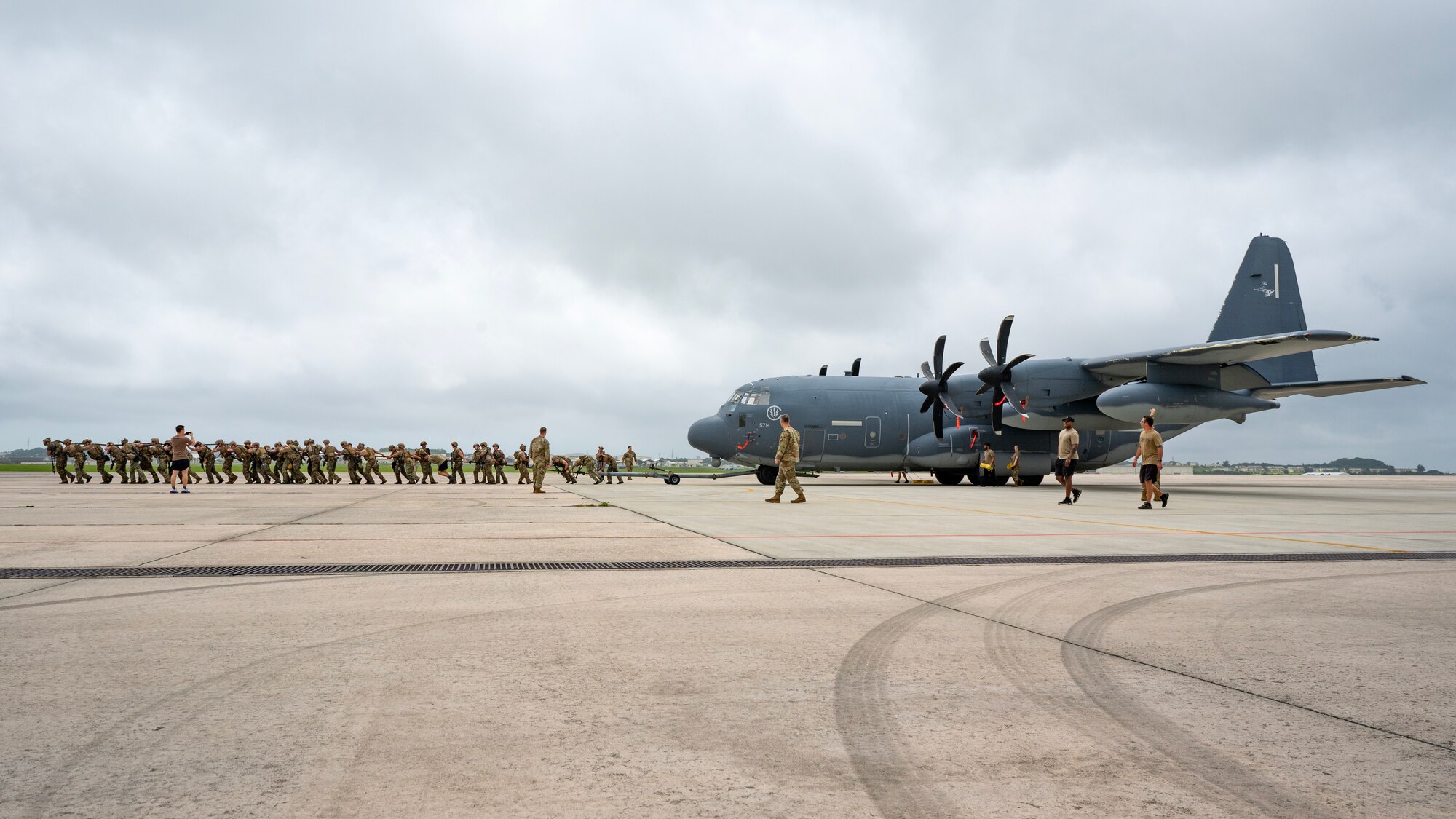 U.S. Air Force special tactics Airmen with the 320th Special Tactics Squadron pull an MC-130J Commando II 150 meters across the parking apron during Monster Mash, an operational readiness and resilience training, at Kadena Air Base, Japan, May 5, 2023. These training events, consisting of various physically and mentally demanding tasks, are routinely conducted among special tactics units to ensure operational readiness and enhance resiliency among the operators. (U.S. Air Force photo by Staff Sgt. Jessi Roth)