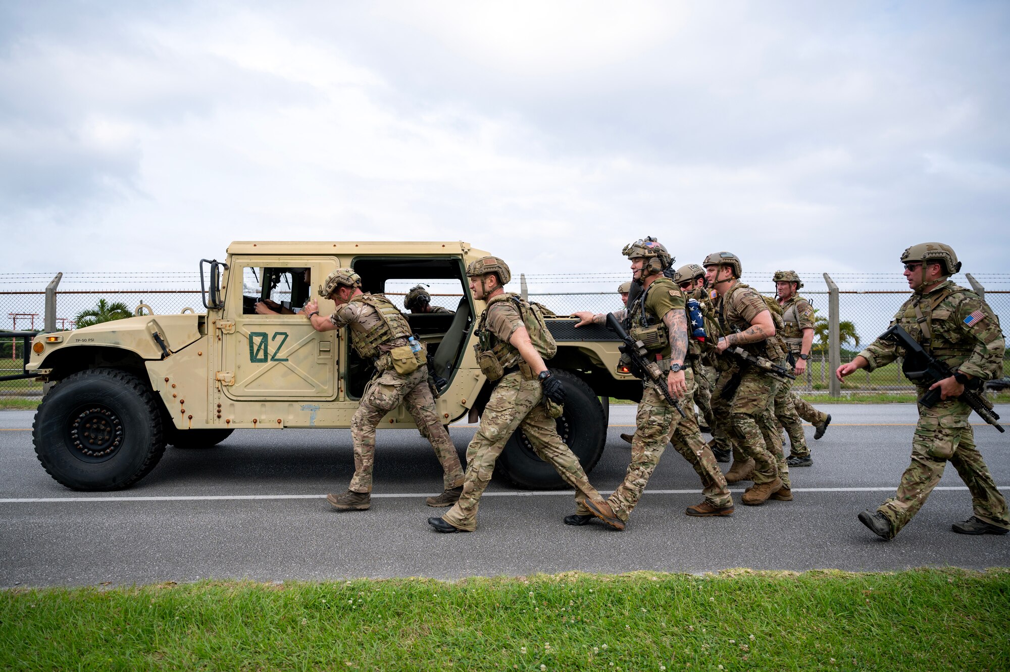 U.S. Air Force special tactics Airmen with the 320th Special Tactics Squadron push a humvee during a Monster Mash challenge at Kadena Air Base, Japan, May 5, 2023. These training events, consisting of various physically and mentally demanding tasks, are routinely conducted among special tactics units to ensure operational readiness and enhance resiliency among the operators. (U.S. Air Force photo by Staff Sgt. Jessi Roth)