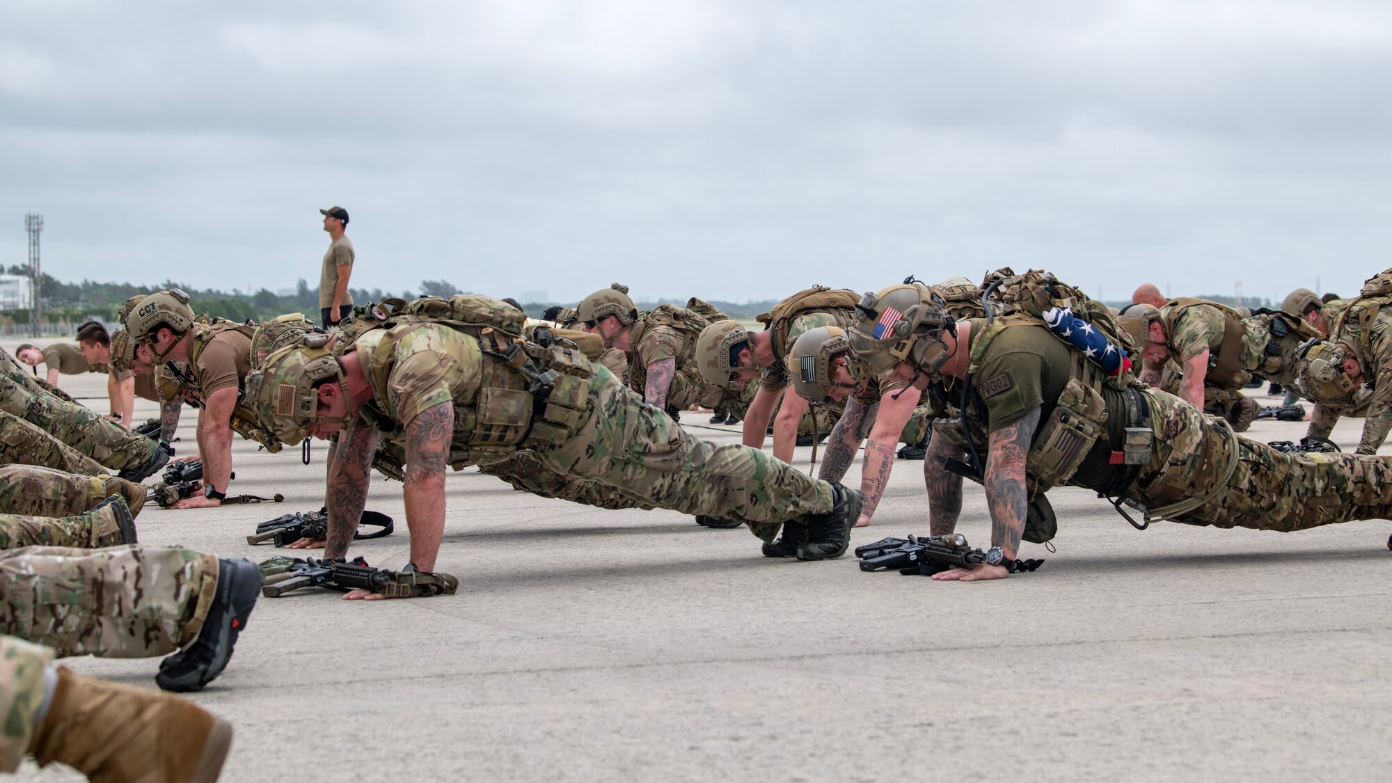 U.S. Air Force special tactics Airmen with the 320th Special Tactics Squadron perform a set of memorial push-ups during Monster Mash, an operational readiness and resilience training, at Kadena Air Base, Japan, May 5, 2023. The push-ups were conducted multiple times throughout the challenge to honor fellow special tactics teammates who lost their lives during the month of May. (U.S. Air Force photo by Staff Sgt. Jessi Roth)