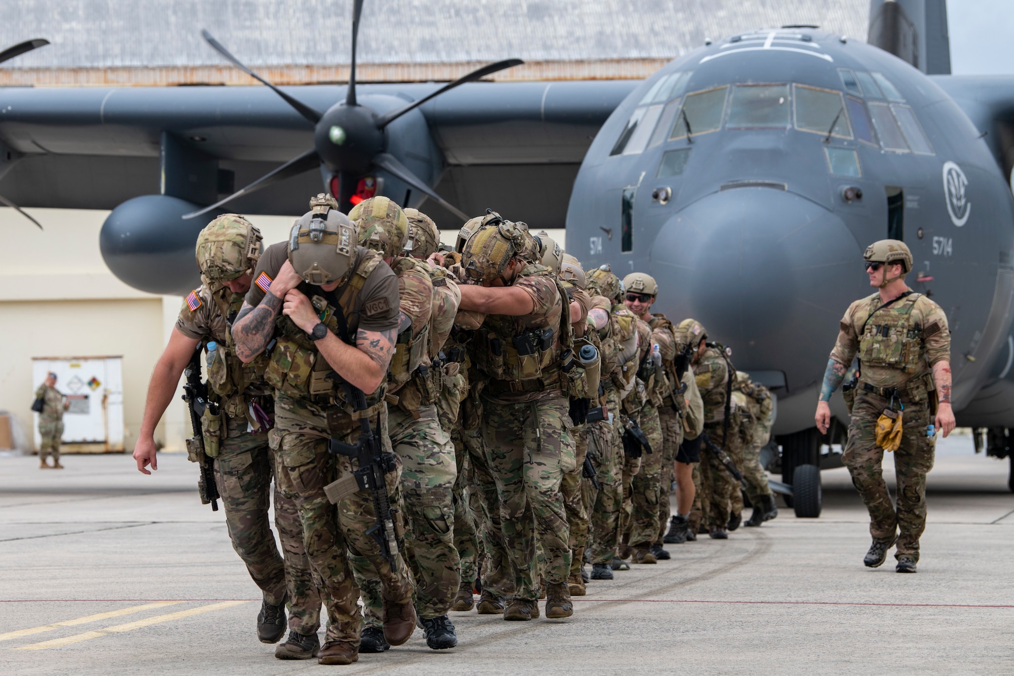 U.S. Air Force special tactics Airmen with the 320th Special Tactics Squadron pull an MC-130J Commando II 150 meters across the parking apron during Monster Mash, an operational readiness and resilience training, at Kadena Air Base, Japan, May 5, 2023. These training events, consisting of various physically and mentally demanding tasks, are routinely conducted among special tactics units to ensure operational readiness and enhance resiliency among the operators. (U.S. Air Force photo by Staff Sgt. Jessi Roth)