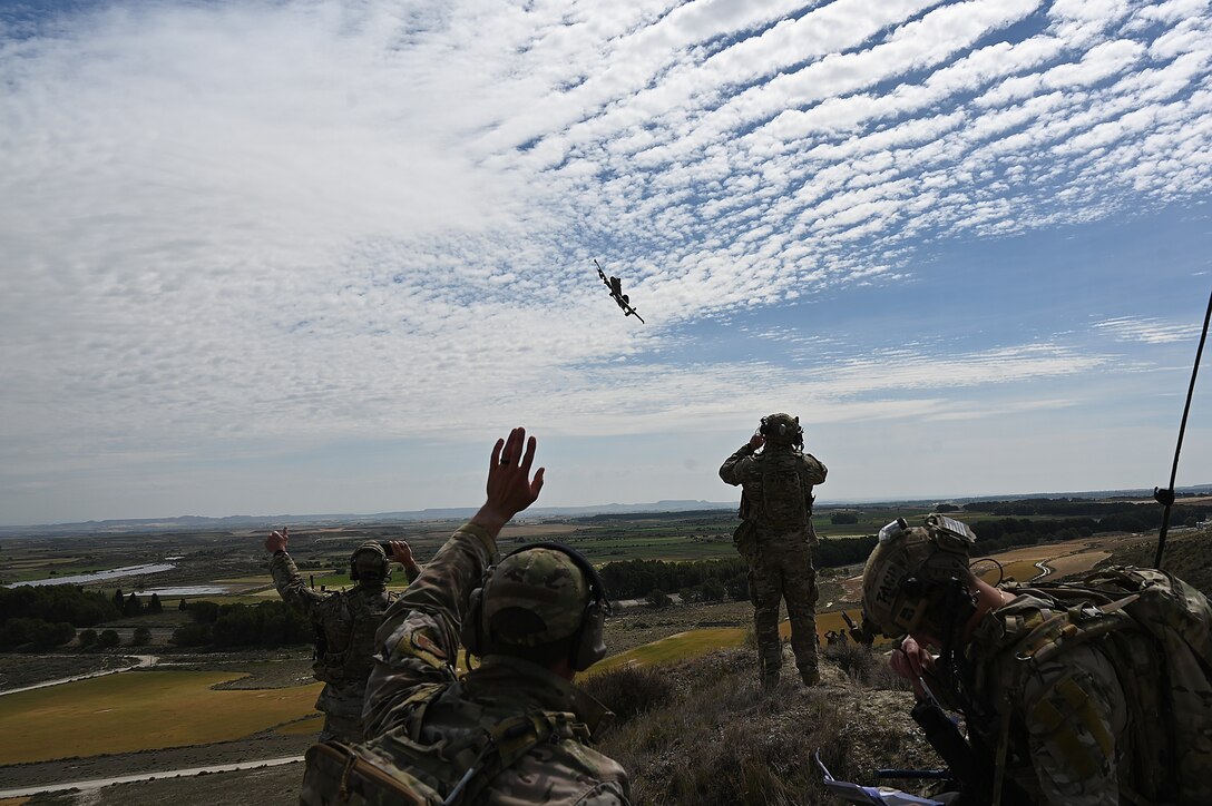 Airmen look at A10 aircraft flying