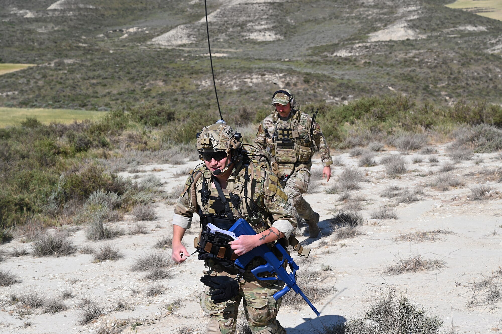 Airmen ascend hill