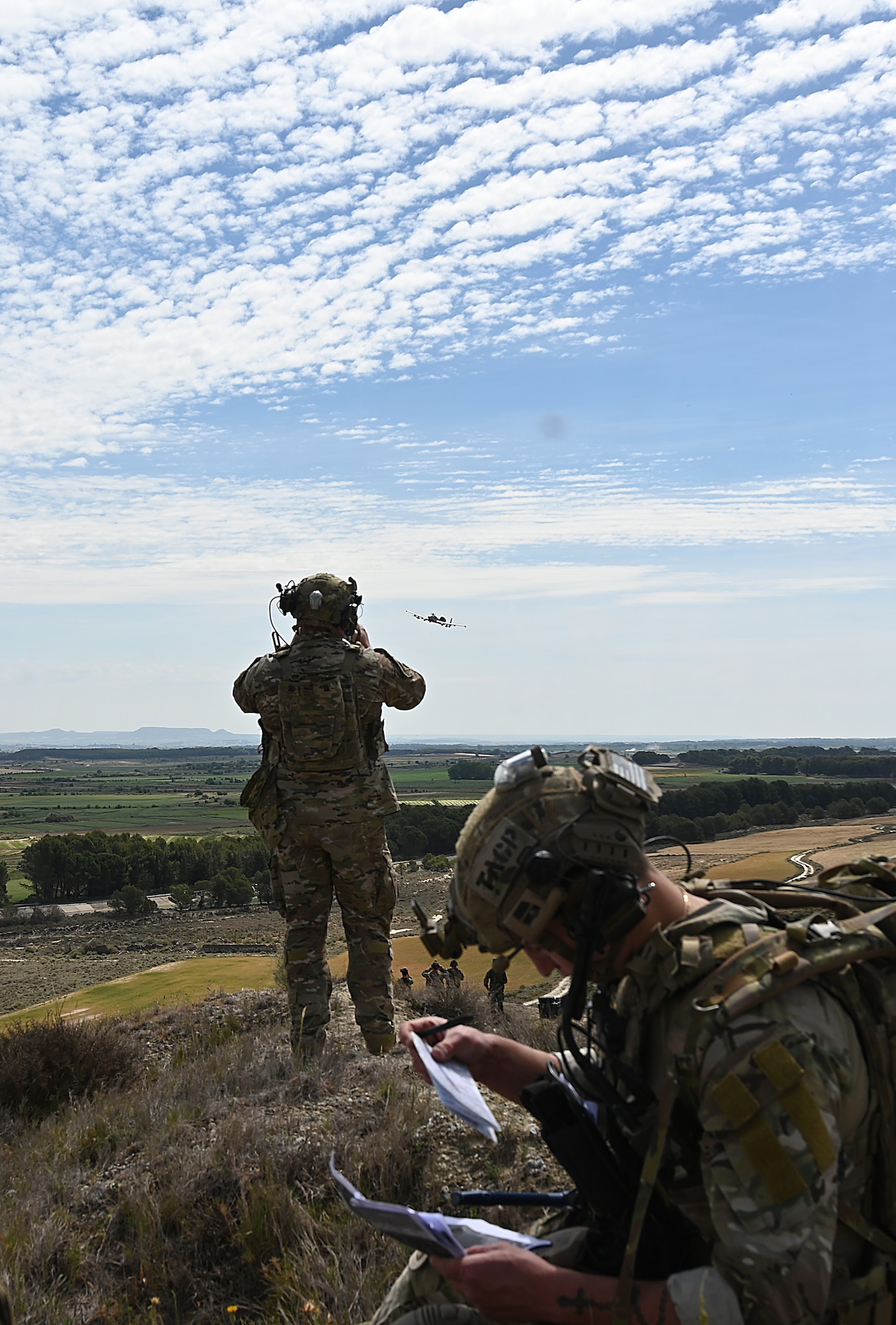 Airman looks through binoculars