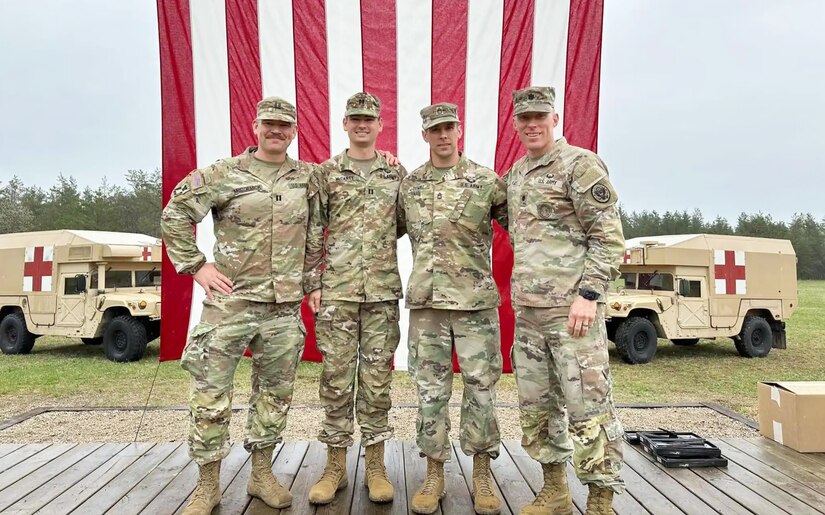 Four soldiers pose for a photo.