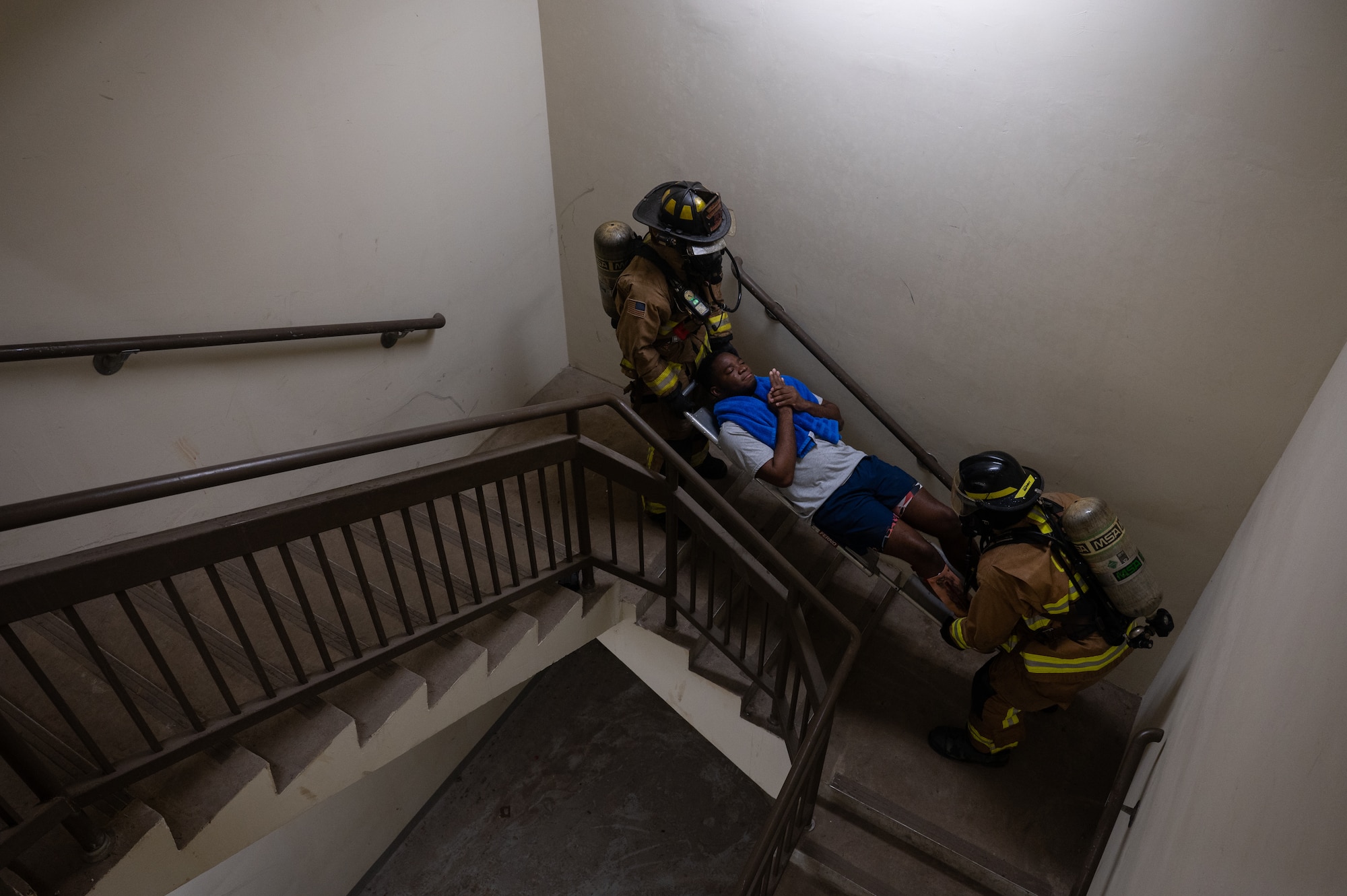 8th Civil Engineer Squadron firefighters, carry a simulated patient up the stairs during a mass casualty training event at Kunsan Air Base