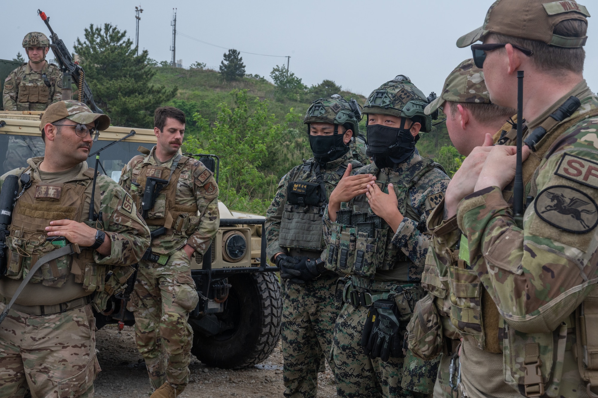 Republic of Korea Army soldiers and U.S. Air Force 8th Security Forces Squadron Defenders debrief following a training event at Kunsan Air Base