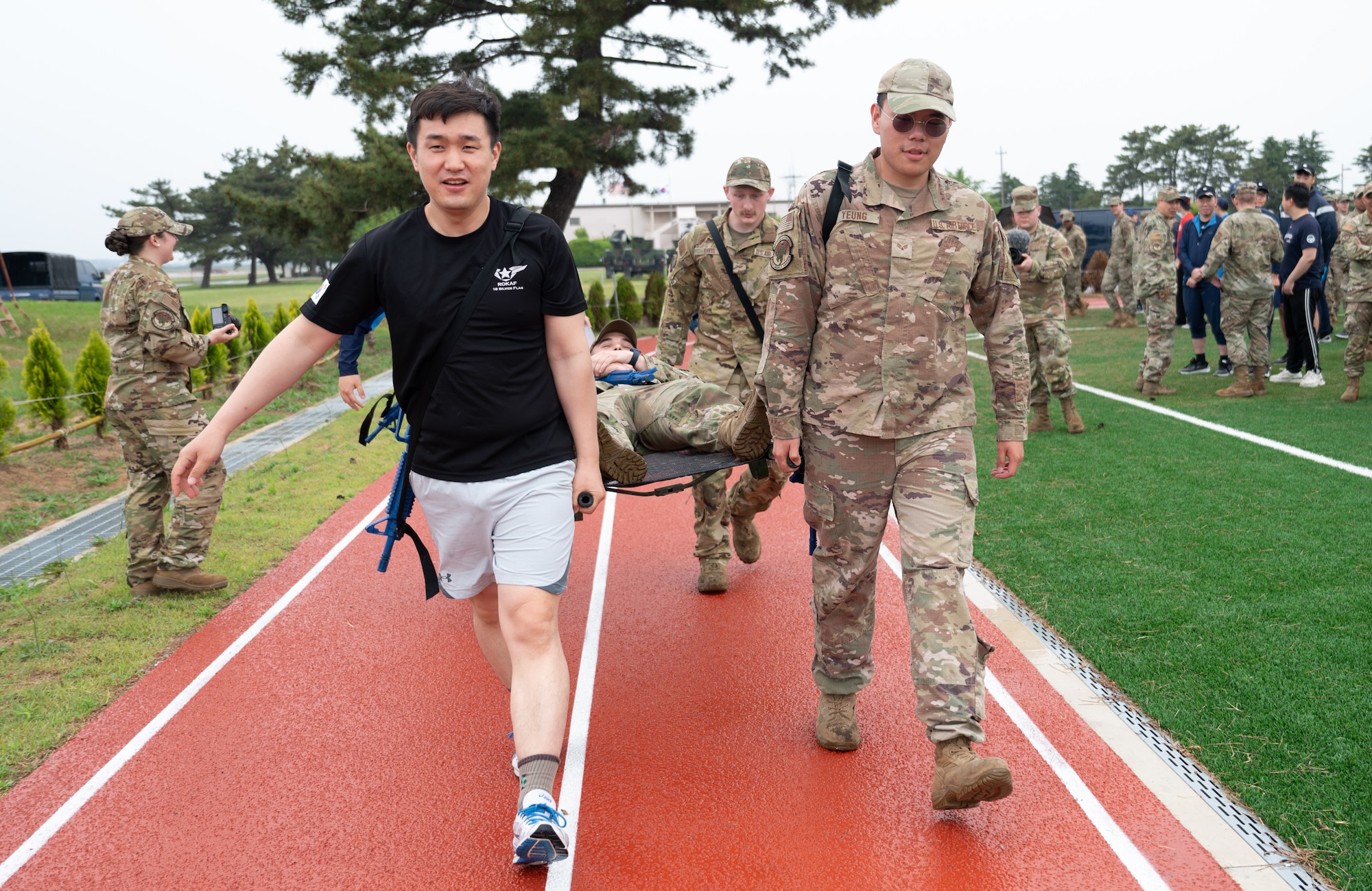 Republic of Korea Air Force 38th Fighter Group and U.S. Air Force 8th Civil Engineer Squadron members perform a litter carry as part of a training event at Kunsan Air Base