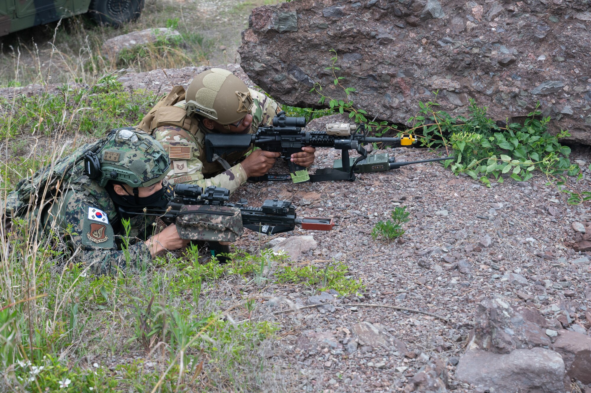 8th Security Forces Squadron Defender, lies prone while providing simulated cover fire alongside a Republic of Korea Army soldier during a training event at Kunsan Air Base