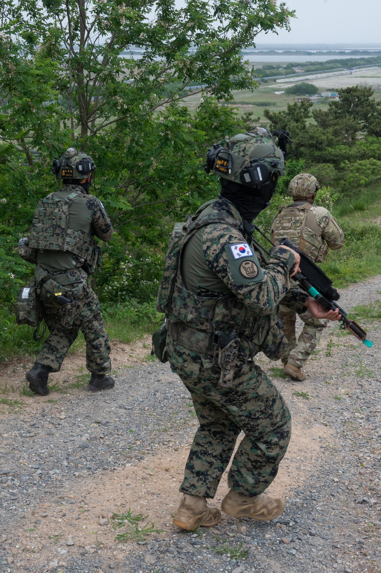 Republic of Korea Army soldiers and U.S. Air Force Tech. Sgt. Keshawn Reedus, 8th Security Forces Squadron Defender, conduct a sweep during a training event at Kunsan Air Base