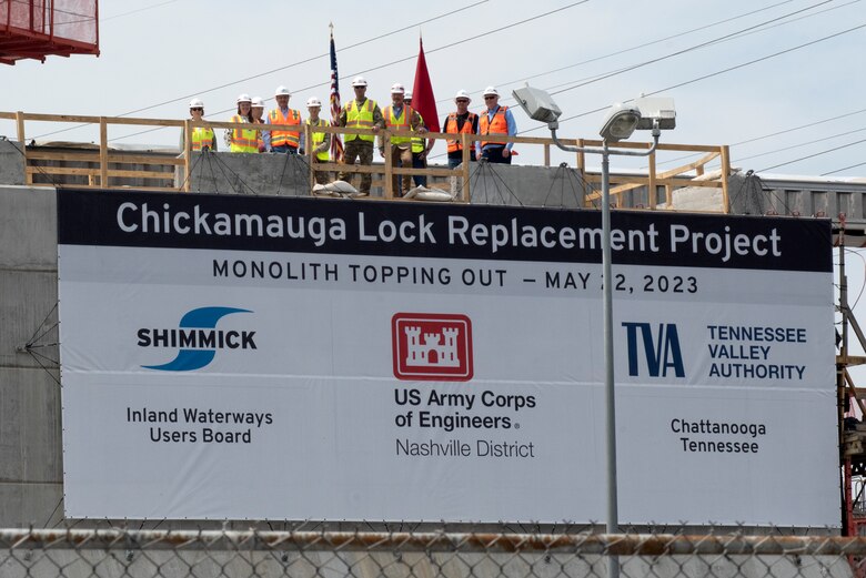 Officials stand atop the first completed monolith May 22, 2023, which is part of the new lock chamber for the Chickamauga Lock Replacement Project on the Tennessee River in Chattanooga, Tennessee. The U.S. Army Corps of Engineers Nashville District and its contractor, Shimmick, held a topping off ceremony marking the completion of the first of 36 monoliths. (USACE Photo by Lee Roberts)