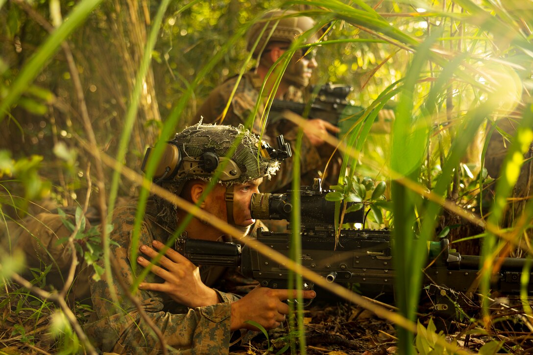 U.S. Marines with 1st Battalion, 2nd Marines  provide security for a platoon attack during Stand-in Force Exercise on Okinawa, Japan, Dec.11, 2022. SiF-EX is a Division-level exercise involving all elements of the Marine Air-Ground Task Force focused on strengthening multi-domain awareness, maneuver, and fires across a distributed maritime environment. This exercise serves as a rehearsal for rapidly projecting combat power in defense of allies and partners in the region. (U.S. Marine Corps photo by Sgt. Mario A. Ramirez)