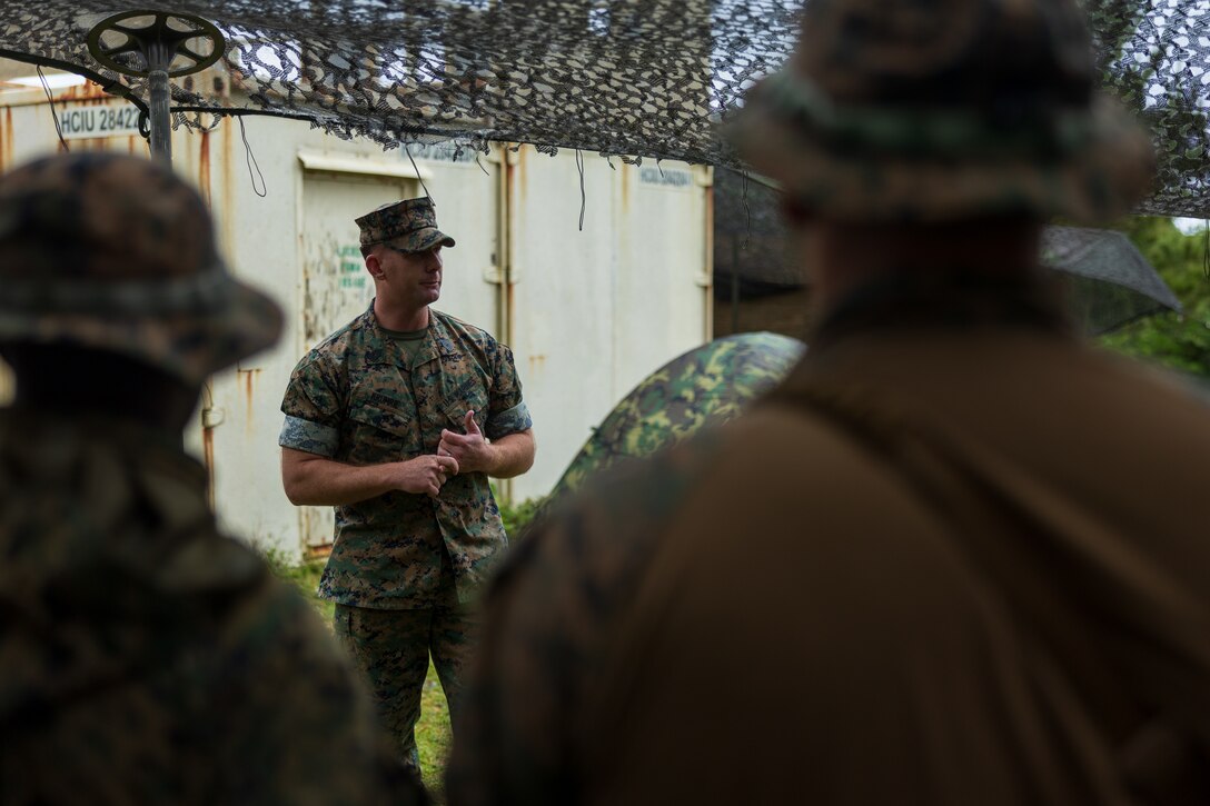 U.S. Marine Corps Master Sgt. Jason Krumrie, the 0311 monitor with Manpower Management Enlisted Assignments 22, speaks to Marines with 1st Battalion, 7th Marines about retention and reenlistment opportunities as part of the MMEA Roadshow in the Central Training Area on Okinawa, Japan, April 26, 2023. During the MMEA Roadshow, career monitors met with members of the Fleet Marine Force to discuss continuing their careers with the new initiatives available under Talent Management 2030. 1st Battalion, 7th Marines is forward-deployed in the Indo-Pacific with 4th Marine Regiment, 3d Marine Division as part of the Unit Deployment Program. Krumrie is a native of Manteno, Illinois. (U.S. Marine Corps photo by Lance Cpl. Jaylen Davis)