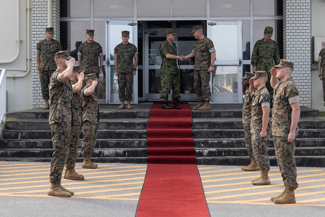 U.S. Marine Corps Lt. Gen. James Beirman, center right, commanding general of III Marine Expeditionary Force, shakes hands with Lt. Gen. Yamane Toshikazu, center, commanding general of Western Army, Japan Ground Self-Defense Force, during a III MEF facilities tour on Camp Courtney, Okinawa, Japan, May 17, 2023. During the inaugural tour, Toshikazu spoke to key III MEF leadership and discussed topics pertaining to strengthening the partnership between III MEF and JGSDF. (U.S. Marine Corps photo by Sgt. Megan Roses)