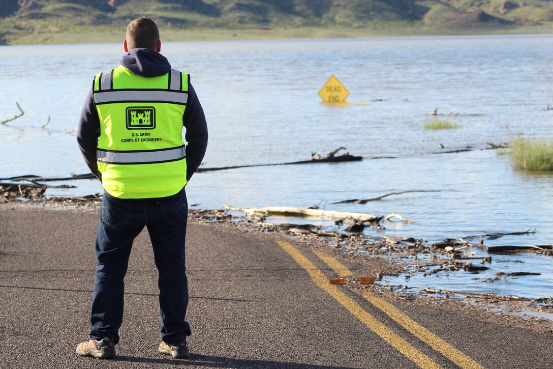 U.S. Army Corps of Engineers dam operator Matthew Ogden reviews flooded areas above Alamo Dam March 23 at the Alamo Lake State Park in western Arizona. Due to heavy rains, the Los Angeles District began a higher-than-normal water release to alleviate flood effects in and around the state park.