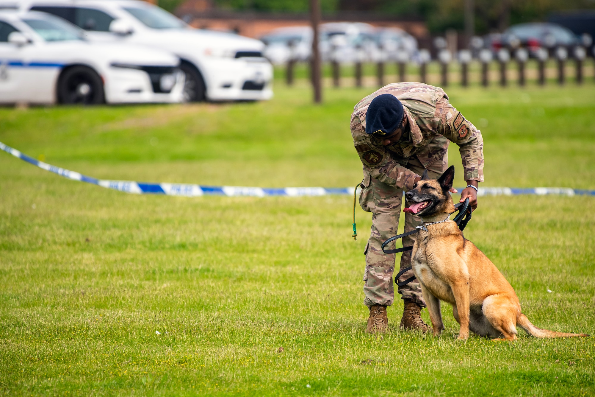 U.S. Air Force Senior Airman Jelani Bell, 100th Security Forces Squadron Military Working Dog handler, relays commands to MWD Uta, during a demonstration at RAF Alconbury, England, May 18, 2023. The demonstration was a part of National Police Week where members from SFS engaged with and demonstrated police capabilities to students from Alconbury Elementary school. (U.S. Air Force photo by Staff Sgt. Eugene Oliver)