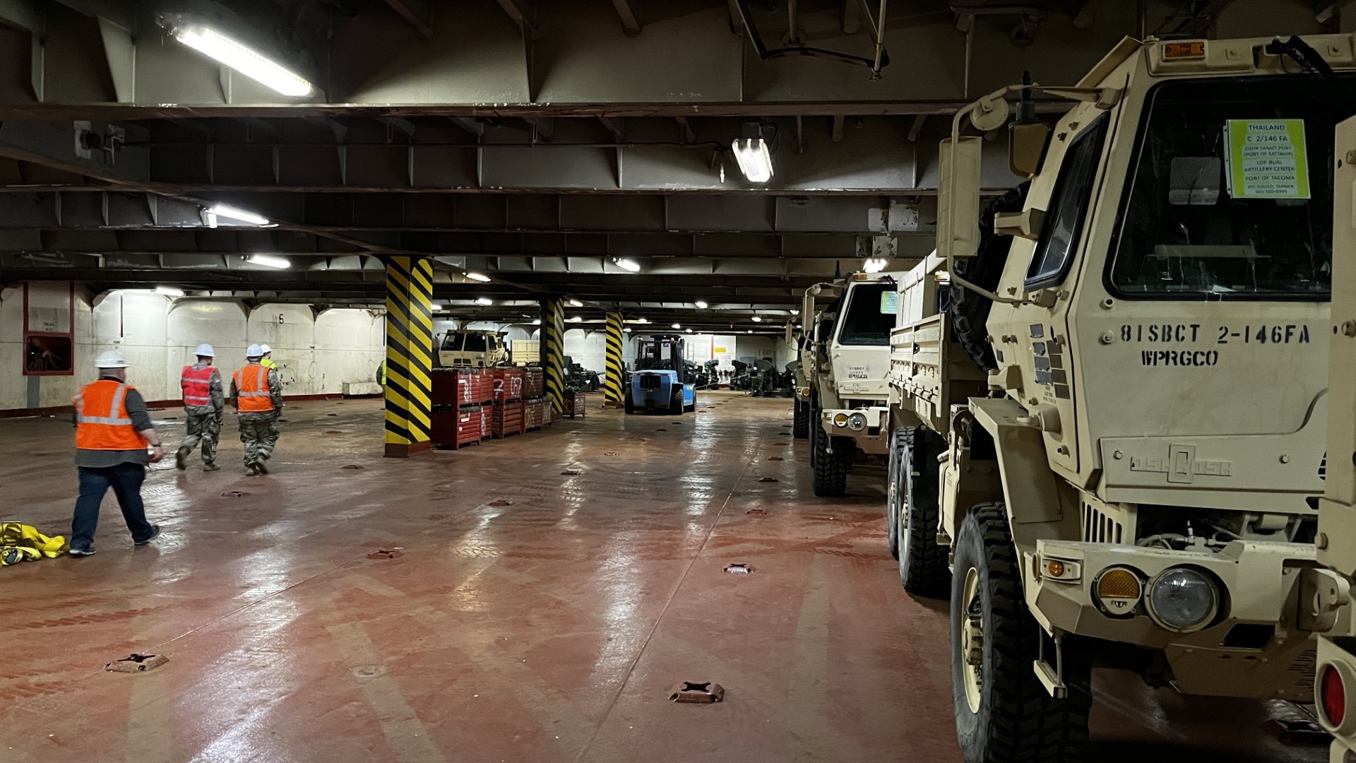 Vehicles from 2nd Battalion, 146th Field Artillery Regiment, Washington National Guard, sit in the loading bay of a cargo ship as it is being loaded for travel to the Kingdom of Thailand prior to Hanuman Guardian 23 on May 23, 2023, at the Port of Tacoma, Wash.