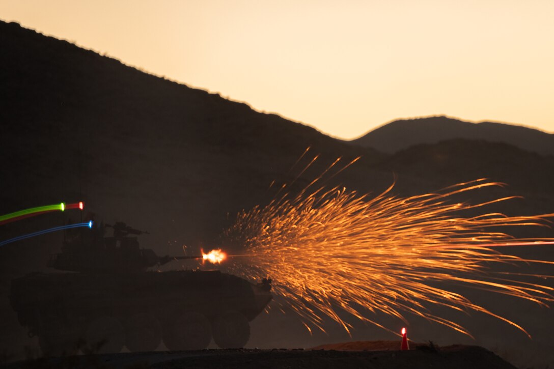 An armored vehicle fires its gun.