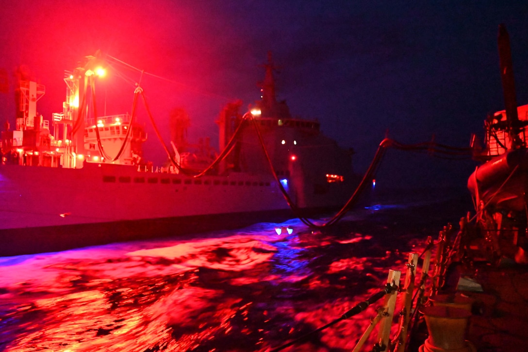 Ships perform a night replenishment.