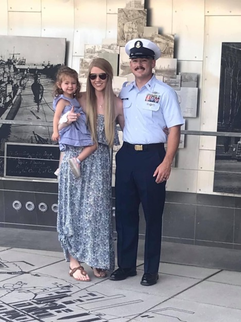 Chief Petty Officer Gentry celebrates his advancement to E7 with his wife, Ashley, and daughter, Abby, on Oct. 22, 2021, at the River Front Park in North Charleston, South Carolina. Photo taken by Ms. Marianne Johnson.